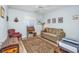 This home has a neutral bedroom that features an olive green sofa and a Tiffany style lamp at 4616 Greenbriar Dr. # H8, Little River, SC 29566
