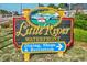 Little River Waterfront sign for dining, shops, and recreation, set on a landscaped property at 4616 Greenbriar Dr. # H8, Little River, SC 29566