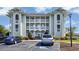 Attractive condo exterior with multiple balconies, well-maintained landscaping, and convenient parking at 4616 Greenbriar Dr. # H8, Little River, SC 29566