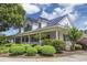 Charming two-story home with metal roof, covered porch, well maintained landscaping, and curb appeal at 4616 Greenbriar Dr. # H8, Little River, SC 29566