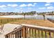 Expansive backyard with lake view, fountain, and an iron fence at 511 Mcalister Dr., Little River, SC 29566