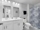 Bright bathroom with double vanity, decorative shower curtain, and modern fixtures at 511 Mcalister Dr., Little River, SC 29566