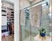 Well-lit bathroom featuring tiled shower and walk-in closet at 511 Mcalister Dr., Little River, SC 29566