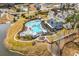 Aerial view of the luxurious community pool and lounge area with an outdoor fireplace at 511 Mcalister Dr., Little River, SC 29566