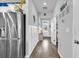 Hallway featuring wood floors, white wainscoting and view of the home's entry at 511 Mcalister Dr., Little River, SC 29566