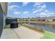 Back patio and lake view featuring landscaping and a grill at 5834 Cremona Dr., Myrtle Beach, SC 29577