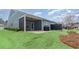 The home's backyard has a covered patio, outdoor grill, and green lawn at 5834 Cremona Dr., Myrtle Beach, SC 29577