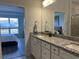 Bathroom featuring granite countertops, double sinks, and access to bedroom at 5834 Cremona Dr., Myrtle Beach, SC 29577