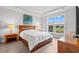 Comfortable bedroom with a view of the backyard pond, natural light, and modern decor at 5834 Cremona Dr., Myrtle Beach, SC 29577