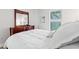 Comfortable bedroom showcasing a queen-sized bed with white linens and a dark wood dresser at 5834 Cremona Dr., Myrtle Beach, SC 29577