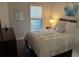 Cozy bedroom with a queen bed, soft lighting, and a mirror at 5834 Cremona Dr., Myrtle Beach, SC 29577