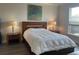 Bedroom with a king-sized bed, two side tables with lamps, and a large window at 5834 Cremona Dr., Myrtle Beach, SC 29577