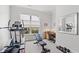 This exercise room features a treadmill, bench, desk and weights, all in a well-lit and organized space at 5834 Cremona Dr., Myrtle Beach, SC 29577