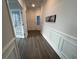 Hallway features wood flooring, white walls, and decorative moldings at 5834 Cremona Dr., Myrtle Beach, SC 29577