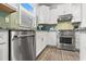 Stainless steel dishwasher and range against the light green backsplash at 5834 Cremona Dr., Myrtle Beach, SC 29577