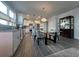 Modern kitchen features white cabinetry, stainless steel appliances, and a large center island with seating at 5834 Cremona Dr., Myrtle Beach, SC 29577