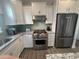 Well-equipped kitchen with stainless steel appliances, white cabinetry, and granite countertops at 5834 Cremona Dr., Myrtle Beach, SC 29577