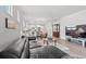 Open concept living room featuring sleek hardwood floors, modern furniture, and natural light at 5834 Cremona Dr., Myrtle Beach, SC 29577