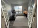 Bright office space with French doors, a desk, and an exercise machine at 5834 Cremona Dr., Myrtle Beach, SC 29577