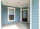 Covered front porch with black front door and sidelight at 5834 Cremona Dr., Myrtle Beach, SC 29577