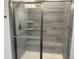 Modern shower with gray tiling, glass doors, and a built-in seat at 5834 Cremona Dr., Myrtle Beach, SC 29577