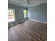 Spacious bedroom with plenty of natural light from two windows and wood look floors at 605 15Th Ave. S, North Myrtle Beach, SC 29582