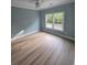 Light-filled bedroom with wood-look floors and a large window at 605 15Th Ave. S, North Myrtle Beach, SC 29582