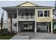 Inviting coastal home with covered parking, front porch, and staircase at 605 15Th Ave. S, North Myrtle Beach, SC 29582