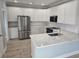 Modern kitchen featuring white cabinets, stainless steel appliances, and quartz countertops at 605 15Th Ave. S, North Myrtle Beach, SC 29582