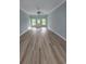 Open-concept living room with wood flooring, recessed lights, and large windows at 605 15Th Ave. S, North Myrtle Beach, SC 29582
