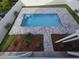Aerial view of the sparkling private pool area surrounded by patio and manicured landscaping at 605 15Th Ave. S, North Myrtle Beach, SC 29582