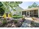 Backyard features a screened in porch and outdoor seating in landscaped garden at 728 Camden Circle, Pawleys Island, SC 29585