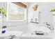 Bright bathroom featuring a soaking tub with a large window and nautical themed decor at 728 Camden Circle, Pawleys Island, SC 29585