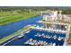 Aerial view of community marina showcasing waterfront condos, a golf course, and a bridge at 870 Monterrosa Dr., Myrtle Beach, SC 29572