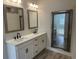 Bright bathroom featuring a double vanity with modern fixtures and large decorative mirrors at 870 Monterrosa Dr., Myrtle Beach, SC 29572