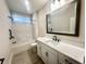 Modern bathroom featuring tiled floor, marble countertop, vanity, framed mirror, toilet, and shower at 870 Monterrosa Dr., Myrtle Beach, SC 29572