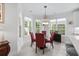 Bright dining area with bay windows, a modern light fixture, and a glass-top table with red chairs at 870 Monterrosa Dr., Myrtle Beach, SC 29572