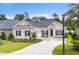 Charming one-story brick home featuring a well-manicured lawn, black shutters, and a cozy, inviting entrance at 870 Monterrosa Dr., Myrtle Beach, SC 29572