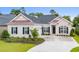 Beautiful one-story home features a brick facade, black shutters, and a well-manicured lawn at 870 Monterrosa Dr., Myrtle Beach, SC 29572
