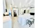 Open kitchen with white cabinets, marble countertops, barstool seating and stainless-steel appliances with tile flooring at 870 Monterrosa Dr., Myrtle Beach, SC 29572