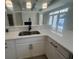Modern kitchen featuring stainless steel sink, white cabinets, quartz countertops, and neutral color palette at 870 Monterrosa Dr., Myrtle Beach, SC 29572