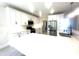 Open concept kitchen featuring stainless steel appliances, island with sink, quartz countertops, and white cabinetry at 870 Monterrosa Dr., Myrtle Beach, SC 29572