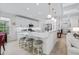 Open-concept kitchen featuring white cabinets, stainless steel appliances, a center island, and bar seating at 870 Monterrosa Dr., Myrtle Beach, SC 29572
