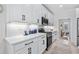 Modern kitchen featuring white cabinets, quartz countertops, stainless steel appliances, and a stylish backsplash at 870 Monterrosa Dr., Myrtle Beach, SC 29572