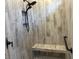 Tiled walk-in shower with a built-in bench, matte black fixtures, and a rainfall shower head at 870 Monterrosa Dr., Myrtle Beach, SC 29572
