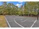 The community has a full sized basketball court surrounded by a white fence and trees at 2629 Scarecrow Way, Myrtle Beach, SC 29579