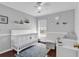 Bedroom with hardwood floors, changing table and crib at 2629 Scarecrow Way, Myrtle Beach, SC 29579