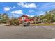 Community clubhouse with blue skies, a paved parking lot, and a well-maintained lawn at 2629 Scarecrow Way, Myrtle Beach, SC 29579