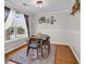 Dining area with a wooden table, modern chairs, neutral walls, and lots of natural light at 2629 Scarecrow Way, Myrtle Beach, SC 29579