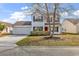 Charming two-story home with a well-maintained lawn, attached garage, and red front door at 2629 Scarecrow Way, Myrtle Beach, SC 29579